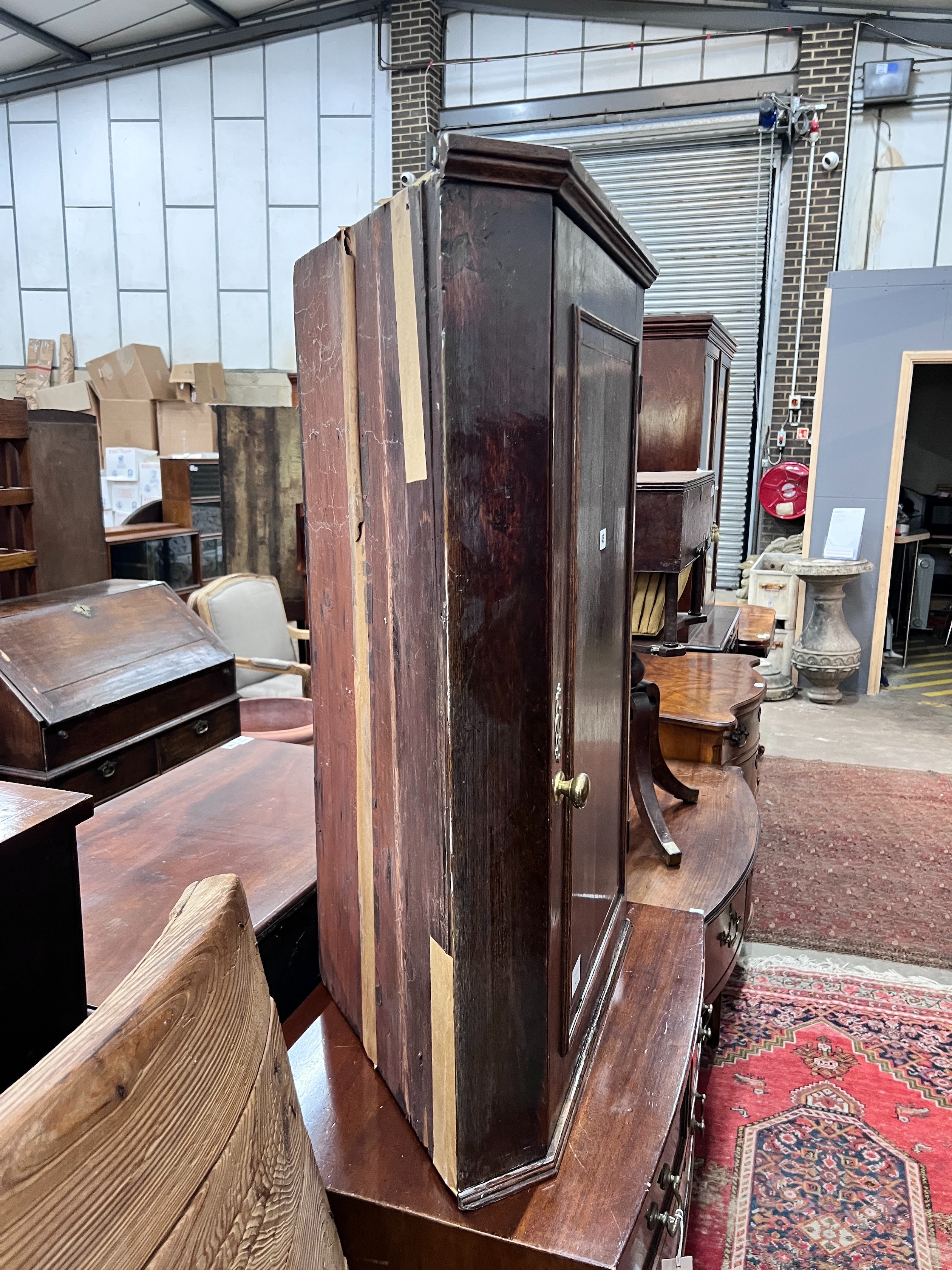 A George III oak hanging corner cupboard, width 69cm, depth 40cm, height 97cm *Please note the sale commences at 9am.